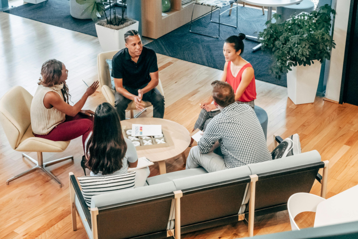 Image of a group of people discussing business growth in an open space building in Oxford