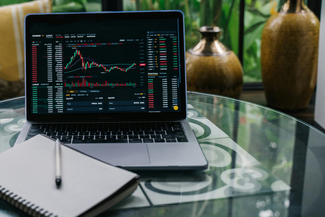 Photo of a laptop and a trading platform