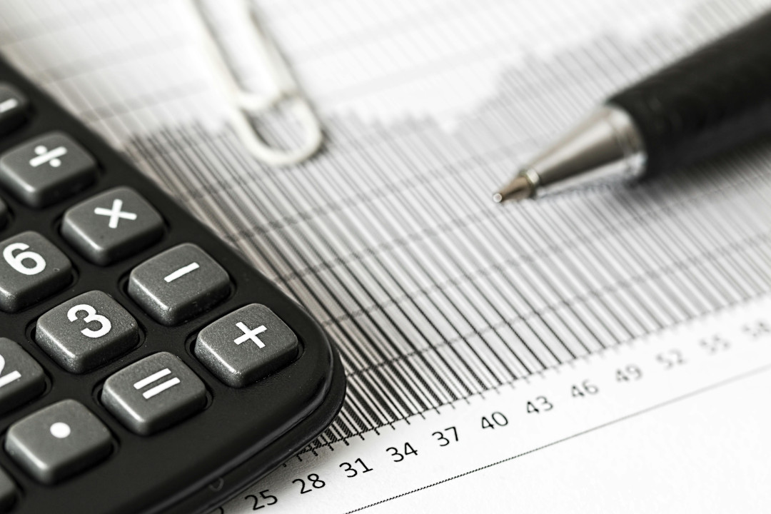 Photo of a calculator, document and a pen